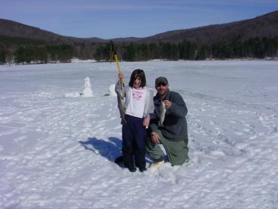 Father and Daughter holding fish they caught ice fishing at Allegany State Park