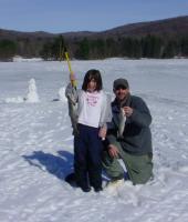 Father and Daughter holding fish they caught ice fishing at Allegany State Park